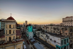 A sunset shot a rooftop in New Havana, Cuba along Galiano Avenue